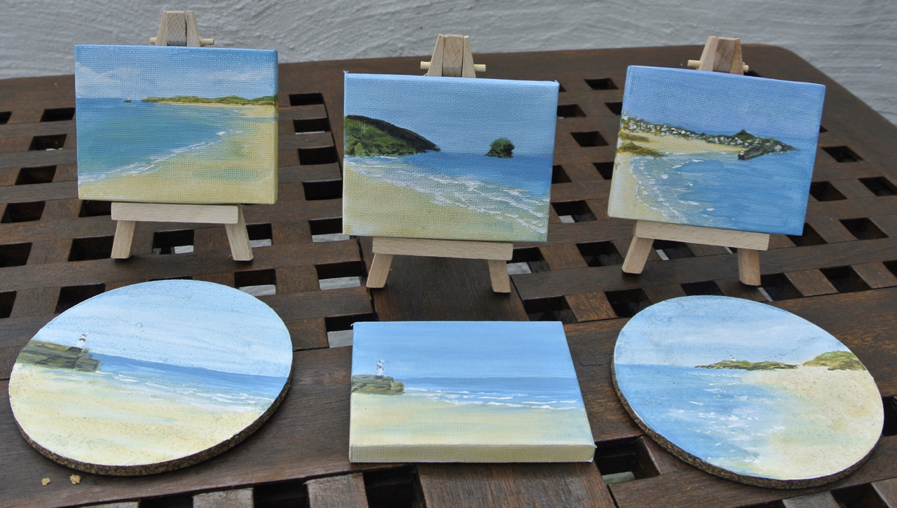 Selection of miniature paintings and drinks mats
