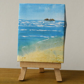 Painting of Godrevy Lighthouse sat on its own easel